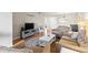 A cozy living room, furnished with neutral-toned seating, complemented by hardwood floors at 952 Virginia St # 108, Dunedin, FL 34698