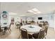 Large meeting room with tables, chairs, and entertainment area, perfect for gatherings at 952 Virginia St # 108, Dunedin, FL 34698