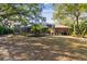 Expansive backyard featuring a screened-in lanai and lush landscaping surrounding the property at 9606 Braden Run, Bradenton, FL 34202