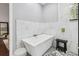 Luxury bathroom with modern tub, glass block window, and stone floor, offering a serene retreat at 9606 Braden Run, Bradenton, FL 34202