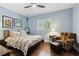 Comfortable bedroom with hardwood floors, window, soft natural light, and a cozy sitting area at 9606 Braden Run, Bradenton, FL 34202