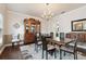Elegant dining room featuring a large table, decorative china cabinet, and a stylish chandelier at 9606 Braden Run, Bradenton, FL 34202