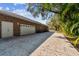 Long driveway leading to a brick home with an attached two car garage at 9606 Braden Run, Bradenton, FL 34202