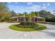 Stunning brick home boasts a circular driveway with lush palm trees and meticulously maintained landscaping at 9606 Braden Run, Bradenton, FL 34202