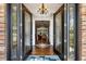 Elegant foyer with hardwood floors, decorative glass doors, and a view into the spacious living area at 9606 Braden Run, Bradenton, FL 34202