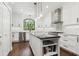 Well-lit kitchen with white cabinetry, stainless steel appliances, subway tile backsplash, and functional island at 9606 Braden Run, Bradenton, FL 34202