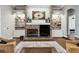 Cozy living room featuring a brick fireplace, built-in shelving, and stylish decor, creating a warm ambiance at 9606 Braden Run, Bradenton, FL 34202