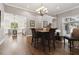 Open-concept living and dining area with hardwood floors and ample natural light, creating a welcoming atmosphere at 9606 Braden Run, Bradenton, FL 34202