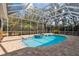 Screened in pool and spa area features brick pavers and lush landscaping at 9606 Braden Run, Bradenton, FL 34202