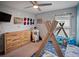 Playful bedroom with a wood tee-pee style bed, ceiling fan and whimsical rocket-themed decor at 9636 Channing Hill Dr, Ruskin, FL 33573