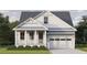 Charming home featuring a light-filled front porch and attached garage, all nestled on a well-manicured lawn at 1000 46Th N Ave, St Petersburg, FL 33703