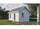 Back view of a shed-style home, boasting white siding and a well-maintained lawn with pathway at 1000 46Th N Ave, St Petersburg, FL 33703