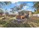 Backyard featuring a hot tub, wooden deck, shaded patio, and landscaped surroundings at 10373 54Th N Ave, St Petersburg, FL 33708