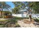 Landscaped backyard with stone walkway, hot tub, mature trees, and privacy fence at 10373 54Th N Ave, St Petersburg, FL 33708