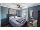 Comfortable bedroom featuring a ceiling fan, neutral-toned curtains, and minimalist decor at 10373 54Th N Ave, St Petersburg, FL 33708