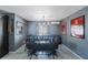 Dining room with modern industrial style table and bench with unique lighting fixture at 10373 54Th N Ave, St Petersburg, FL 33708