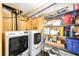 Functional laundry room with modern washer and dryer units, shelving, and storage space at 10373 54Th N Ave, St Petersburg, FL 33708
