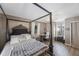 Main bedroom featuring natural light, wood flooring, a four-poster bed, and a desk at 10373 54Th N Ave, St Petersburg, FL 33708