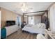 Bedroom featuring a four-poster bed, hardwood floors, a ceiling fan and an ensuite bathroom at 10373 54Th N Ave, St Petersburg, FL 33708