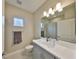Well-lit bathroom featuring a modern vanity, neutral tones, and a large mirror at 11008 Sand Pine Ln, Parrish, FL 34219