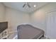 A minimalist bedroom with a ceiling fan, and closet door offering simple comfort and convenience at 11008 Sand Pine Ln, Parrish, FL 34219