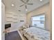 Cozy bedroom with stylish wall shelves, a patterned armchair, and neutral tones at 11008 Sand Pine Ln, Parrish, FL 34219