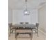 Dining room features modern light fixture, neutral tones and seats six at 11008 Sand Pine Ln, Parrish, FL 34219