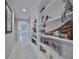 Inviting hallway with built-in shelving adorned with decorative items and personal mementos at 11008 Sand Pine Ln, Parrish, FL 34219