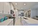 Well-lit kitchen features white cabinetry, stainless steel appliances, and ample counter space at 11008 Sand Pine Ln, Parrish, FL 34219