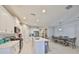 Modern kitchen features stainless steel appliances, a center island, and an adjacent dining area at 11008 Sand Pine Ln, Parrish, FL 34219