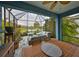 Lanai featuring outdoor dining and conversation areas overlooking the yard and pond at 11008 Sand Pine Ln, Parrish, FL 34219