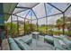 Outdoor lanai with a conversation seating area around a fire pit with views of the pond at 11008 Sand Pine Ln, Parrish, FL 34219