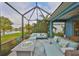 Lanai boasts cozy seating, a pond view, and a fire pit, perfect for relaxation and gatherings at 11008 Sand Pine Ln, Parrish, FL 34219