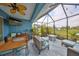 Well-appointed lanai with outdoor dining and seating overlooking the pond at 11008 Sand Pine Ln, Parrish, FL 34219