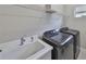 Practical laundry room with sink and modern Samsung washer and dryer for efficient chores at 11008 Sand Pine Ln, Parrish, FL 34219