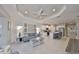 Spacious living room with modern décor, white trim and recessed lighting flowing into an open-concept kitchen at 11008 Sand Pine Ln, Parrish, FL 34219