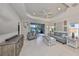Bright living room features an adjacent outdoor patio and refined decor with cozy seating at 11008 Sand Pine Ln, Parrish, FL 34219
