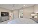 Bright main bedroom featuring a ceiling fan, neutral walls and furniture, and ensuite bathroom at 11008 Sand Pine Ln, Parrish, FL 34219