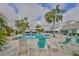 Resort-style community pool with palm trees, lounge chairs, and covered seating areas for residents to enjoy at 11008 Sand Pine Ln, Parrish, FL 34219