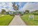 Community recreation center with manicured landscaping, a paved walkway, and a sign, perfect for community gatherings at 11008 Sand Pine Ln, Parrish, FL 34219