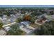 Aerial view of a cozy neighborhood showcasing a lovely single-story home with gray roof and long driveway at 11283 Portsmouth St, Spring Hill, FL 34609