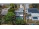 Aerial view of the single Gathering home featuring a screened in pool, patio, and driveway at 11283 Portsmouth St, Spring Hill, FL 34609