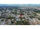Wide angle aerial view of home and neighborhood, surrounded by green spaces, and located in a residential area at 11283 Portsmouth St, Spring Hill, FL 34609