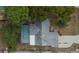 Aerial view of home with screened-in pool, patio area, mature trees, and well-kept lawn at 11283 Portsmouth St, Spring Hill, FL 34609