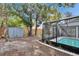 The backyard offers an enclosed pool, storage shed and shady trees at 11283 Portsmouth St, Spring Hill, FL 34609