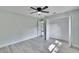Spacious bedroom with a ceiling fan, an open closet and a view to the backyard at 11283 Portsmouth St, Spring Hill, FL 34609