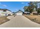 Single-story home with a wide driveway, an attached garage, and well-maintained lawn, perfect for Gathering living at 11283 Portsmouth St, Spring Hill, FL 34609