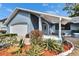 Home exterior featuring well-maintained landscaping and a covered front entrance at 11283 Portsmouth St, Spring Hill, FL 34609