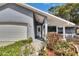 The front of this single-story home has a tiled front porch with well-maintained front yard landscaping at 11283 Portsmouth St, Spring Hill, FL 34609