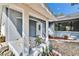 The front porch of this home has tiled flooring, nice landscaping, and an oval glass insert in the front door at 11283 Portsmouth St, Spring Hill, FL 34609